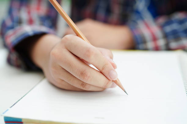 istock Asian teenage student write homework, study lesson for exam online learning education. 1811266080