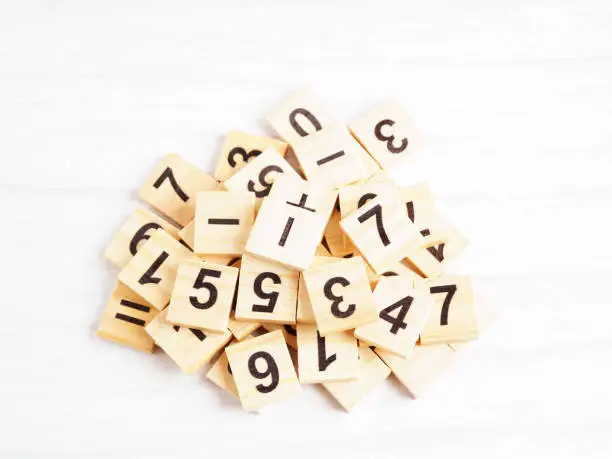 Photo of Number wood block cubes for learning Mathematic, education math concept.