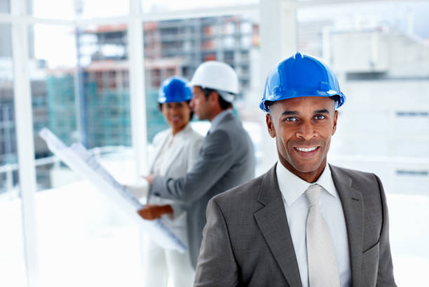 Portrait of a male engineer with colleagues in the background