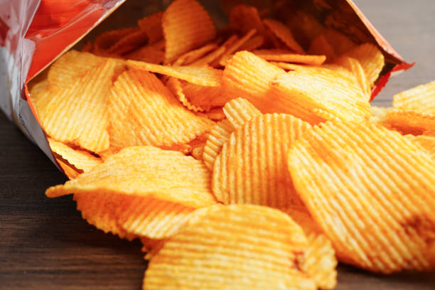 istock Potato chips in open bag, delicious BBQ seasoning spicy for crips, thin slice deep fried snack fast food. 1811275356