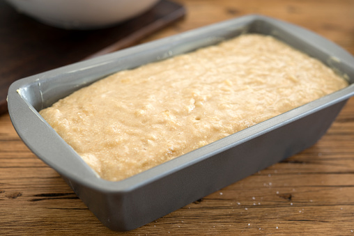 uncooked banana Loaf cake prepared in cake tin for the oven.