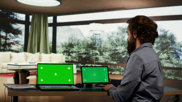 istock Businessperson using greenscreen displays on devices 1811279130