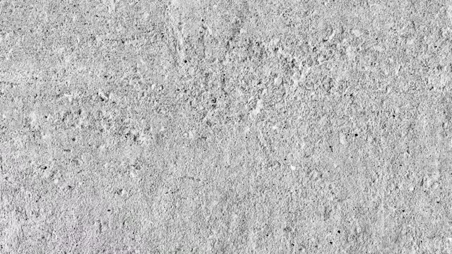 Concrete wall, rough gray surface with irregularities, uniform texture background, rotating, turning, close-up macro, top view