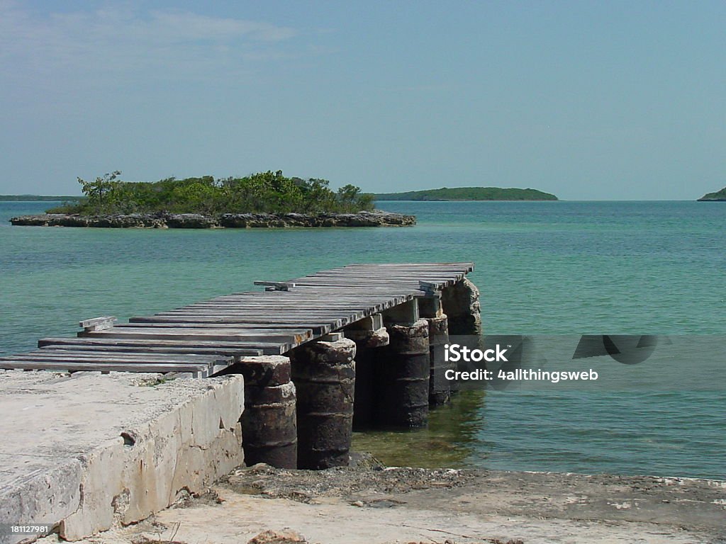 Pier in Carribean Bay Old wooden pier in clear blue Carribean Bay.I have another pier picture. Bay of Water Stock Photo