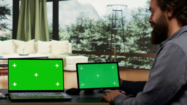 istock Entrepreneur works with greenscreen on laptop and tablet 1811284200