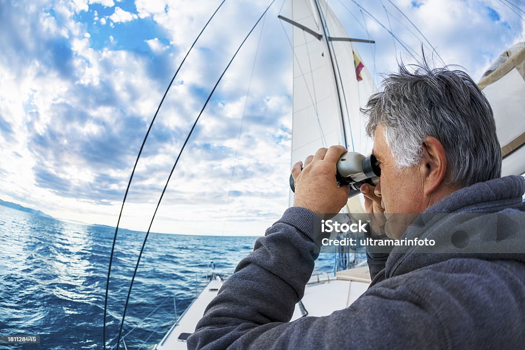Homem em iate olha através de binóculos - Foto de stock de Binóculos royalty-free