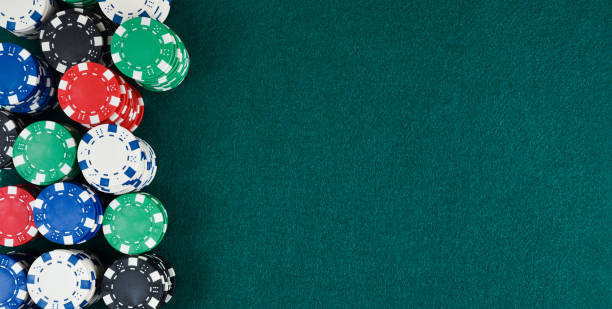 istock Casino gaming background with stacks of chips on green mat 1811285272