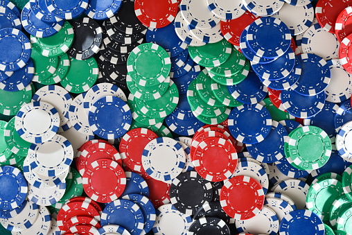 Background with pile of casino chips of different colors. Top view.