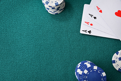 Card game table background with four uncovered aces on the table and betting chips. Top view.
