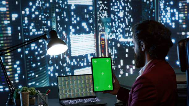 istock Investment analyst checks tablet with greenscreen design 1811286887