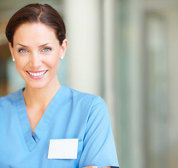 Close-up of a happy female nurse smiling Close-up of a happy female nurse smiling hospital card stock pictures, royalty-free photos & images