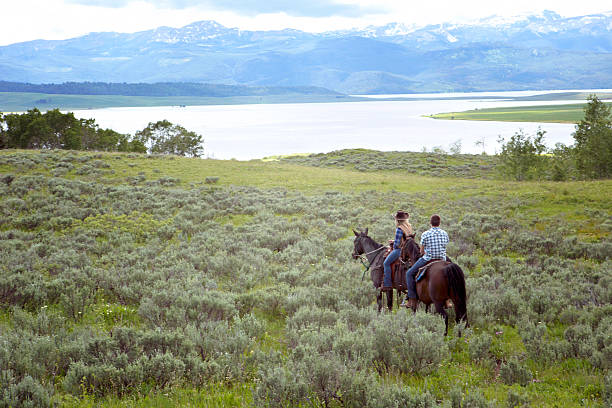 Man enjoying horseback riding by the lake
