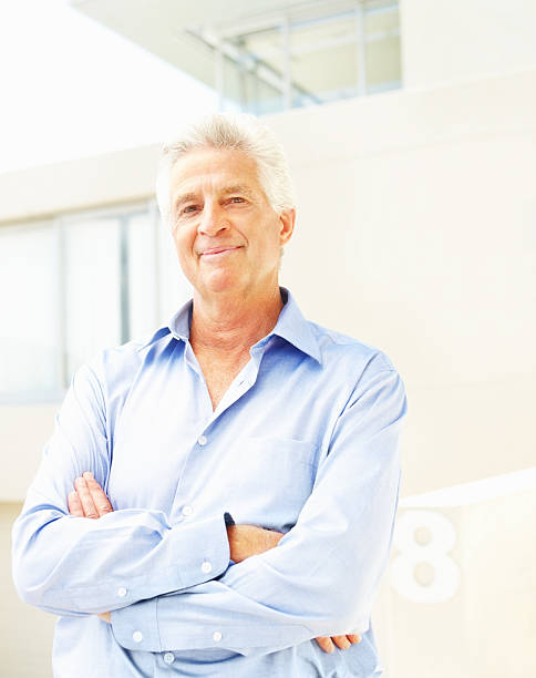 istock Businessman smiling with arms crossed 181129027