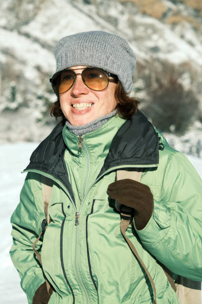 istock 46-year-old female hiker is looking at winter mountain view 1811292280