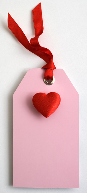 Pink gift tag and red heart with red ribbon on a white background. Other versions in my Sweet Hearts light box.
