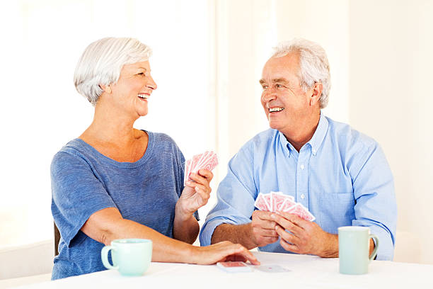 istock Couple Looking At Each Other While Playing Cards 181130462