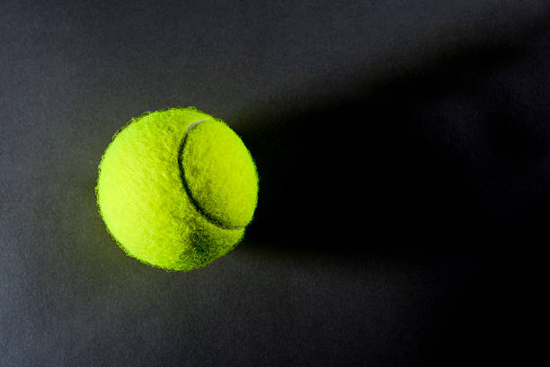 istock Tennis ball on dark background from above 181130999