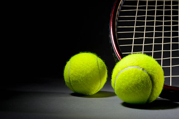 istock Tennis racket and balls on dark background 181131101