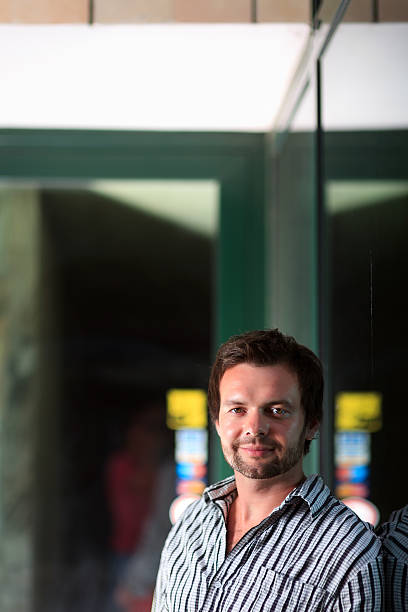 istock Young man by the store entrance 181131150