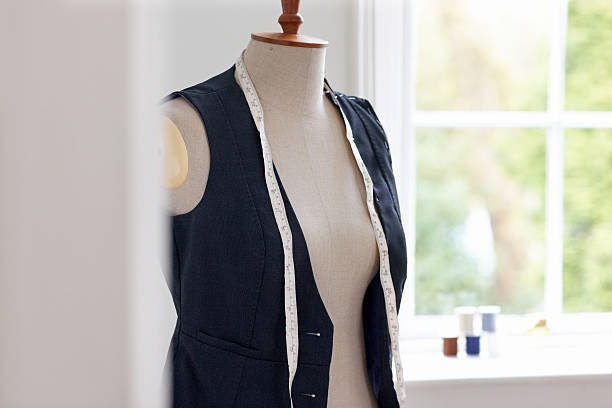 Dressmaker's model with blue jacket and measuring tape
