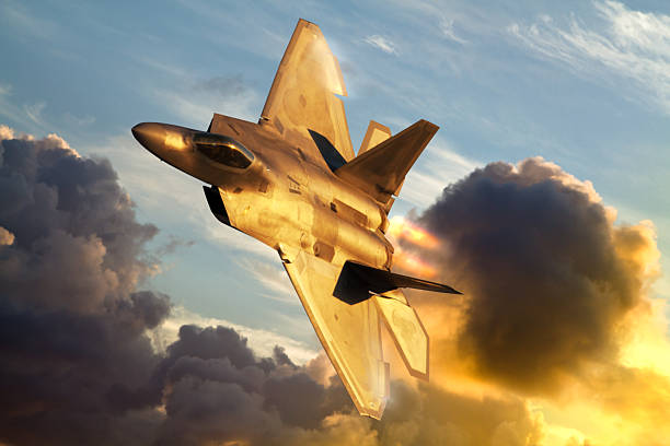 F-22 Raptor flying above clouds stock photo
