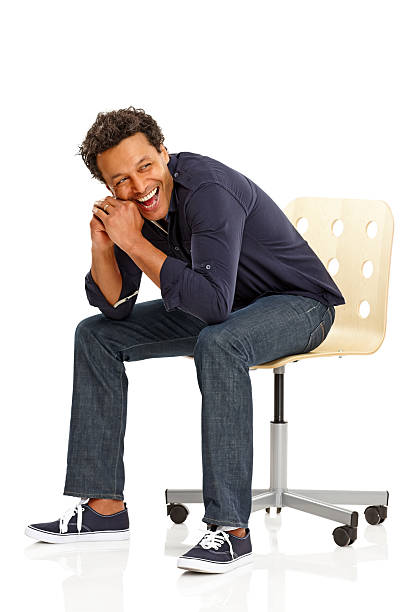 istock Relaxed man sitting on chair looking away and laughing 181132030