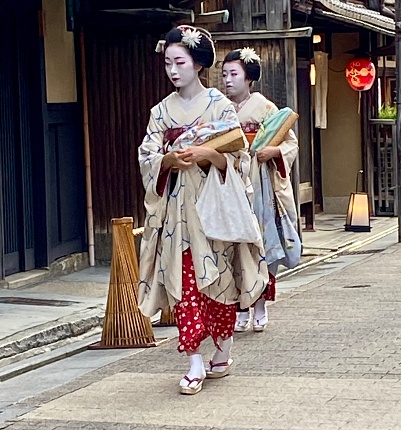 Japan - Kyoto - Gion district - Maiko going at work\n\nA maiko is an apprentice geisha in Kyoto. Their jobs consist of performing songs, dances, and playing the shamisen or other traditional Japanese instruments for visitors during banquets and parties, known as ozashiki.\n\nHere you can see two Maiko ( apprentice geisha) in Kyoto who are walking in the street, make up and dressed, for work \n\n08.07.2023
