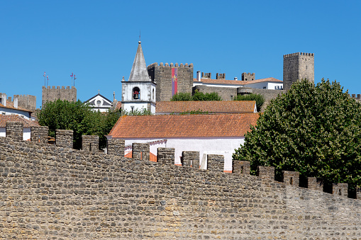 Panoramic view of the beautiful medieval village of Obidos, Portugal, with its typical white facades and the walls.