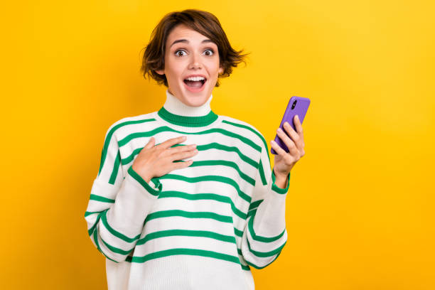 istock Photo of shocked impressed lady wear striped pullover communicating instagram twitter telegram facebook isolated yellow color background 1811336665