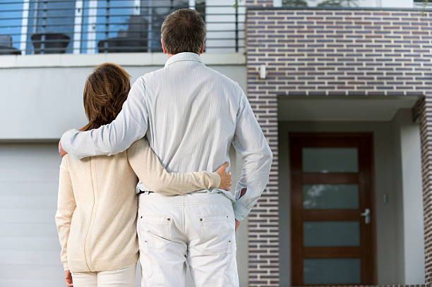 istock Mature couple looking at a house 181133911
