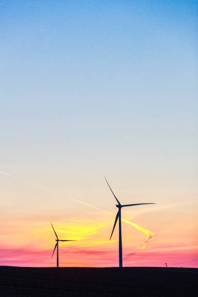 istock Wind farm on agricultural field after sunset, beautiful multicolored sky 1811340943