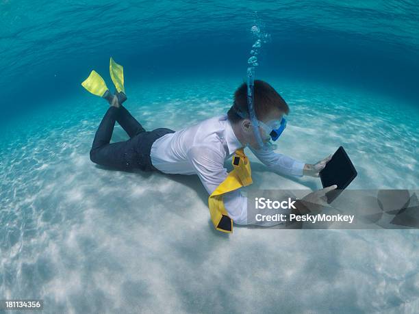 Traveling Businessman Relaxing Using Digital Tablet Underwater Stock Photo - Download Image Now