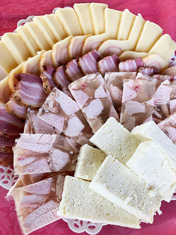A plate with various cheese, salumi and ham. Overhead view.