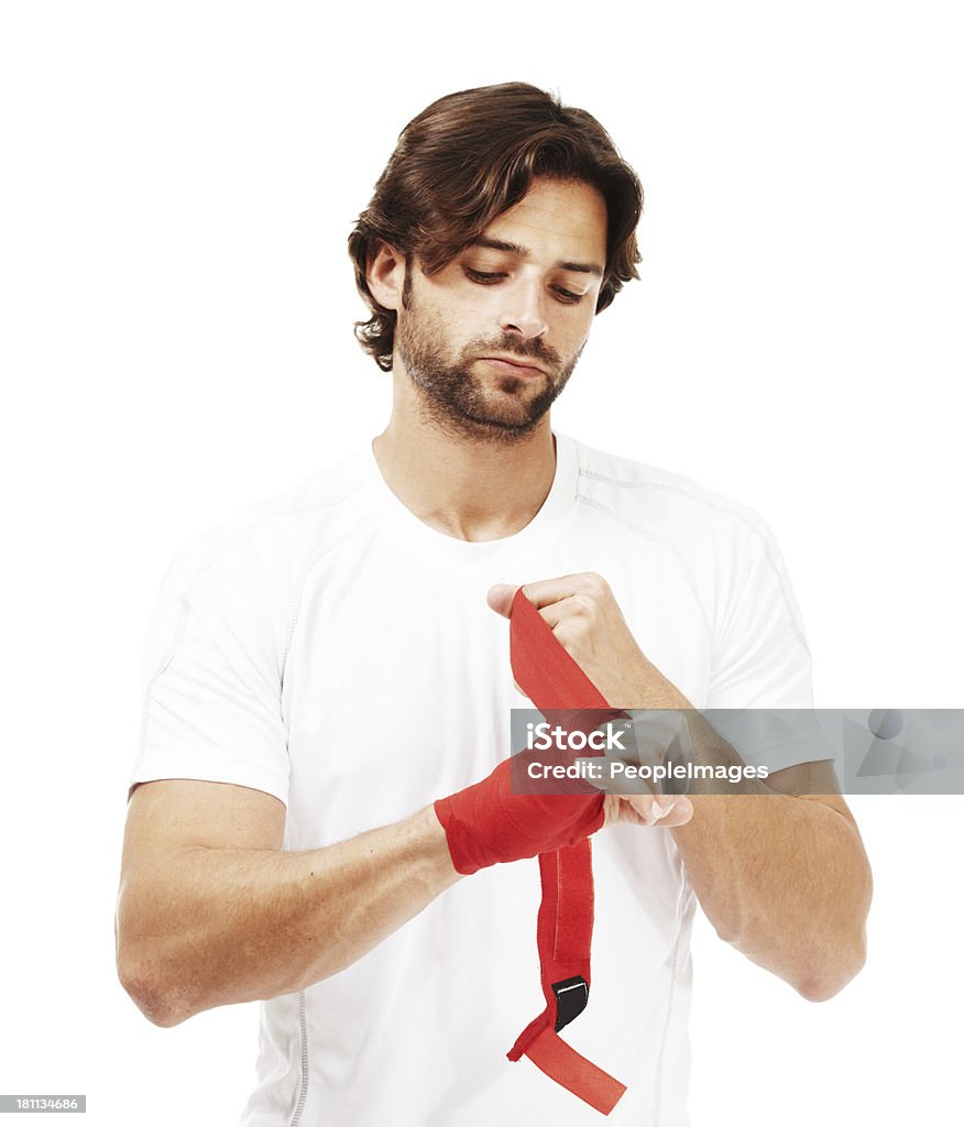 His strong self belief will win him this fight Young fit male wrapping up his hand and wrist with red tape and strapping - isolated on white 20-29 Years Stock Photo