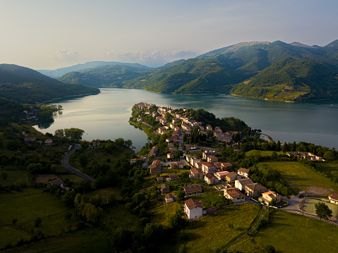 Beautiful landscape italian apennines drone view at sunset Hill and town Colle di Tora at Lago del Turano in Italy