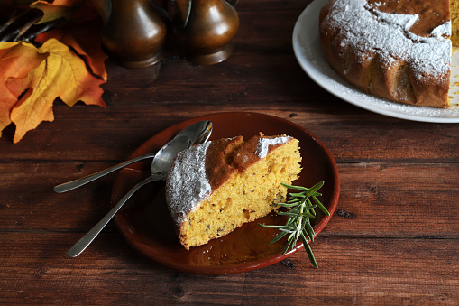 Delicious homemade Halloween pumpkin pie on rustic wooden background. Autumn or winter holidays, Halloween or Thanksgiving day. Overhead view. Copy space.