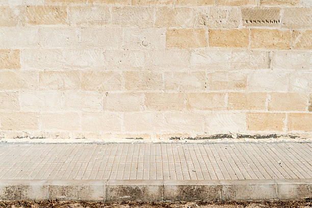 istock Old concrete grunge wall with sidewalk 181134975