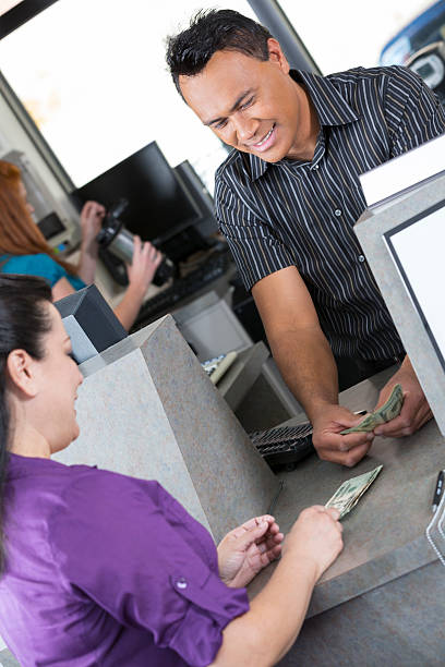 istock Customer at the bank depositing a check 181135202