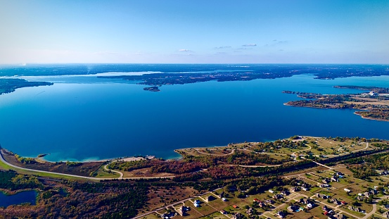Aerial view of the lake Norman area in Iowa, with the lake water reflecting the sky