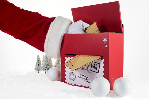 Santa Claus Opening His Mailbox stuffed with letters