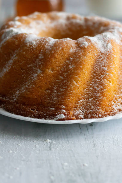 istock Homemade cake with powdered sugar and honey. On wood aphids. 1811362421