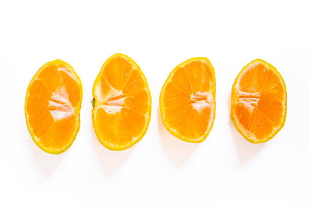 Sliced tangerine isolated on a white background. Top view, copy space.