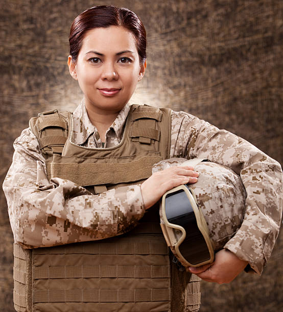 istock Female soldier in combat gear 181136406