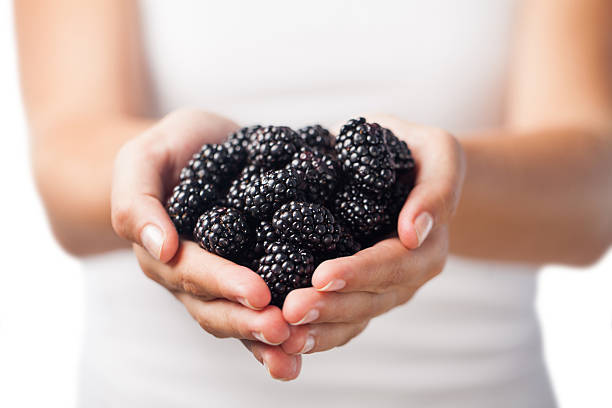 Woman holding blackberries