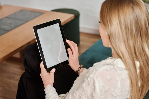istock Woman looking at tablet 1811365475