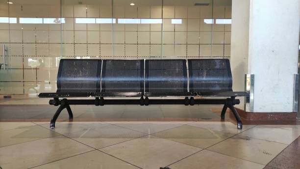 istock Empty metal bench in the airport for visitors to sit or take a rest while waiting for flight or arrival 1811366009