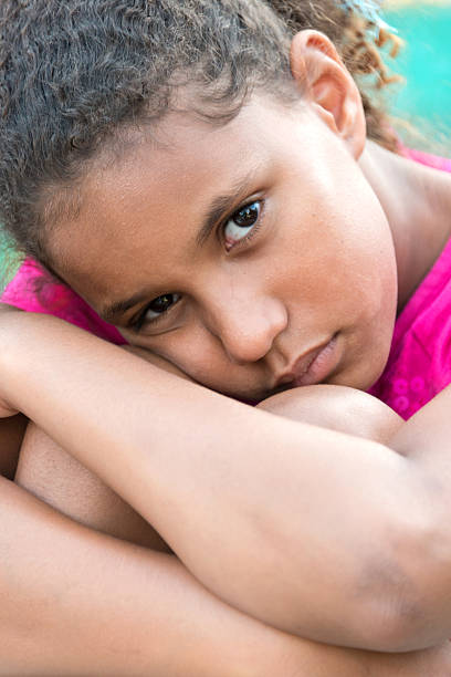Sad Girl Sad nine years old afro caribbean nine years old girl sad girl crouching stock pictures, royalty-free photos & images