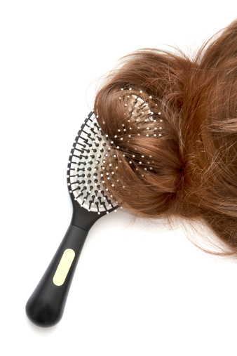 Comb brush with hair on white background
