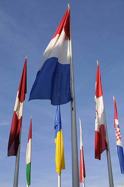 カラフルな旗 - national flag flag global communications sky ストックフォトと画像