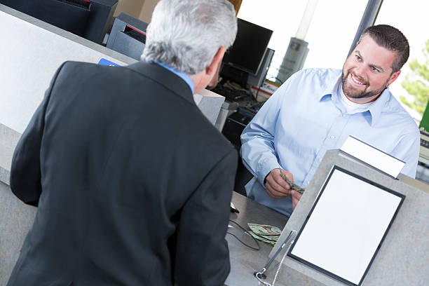 istock Customer at the bank depositing a check 181137676